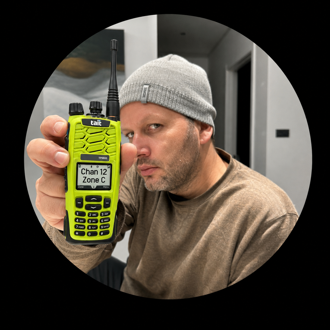 Collection of A man wearing a gray beanie and brown shirt holds up a bright neon yellow-green walkie-talkie with a black antenna.  in a gallery layout