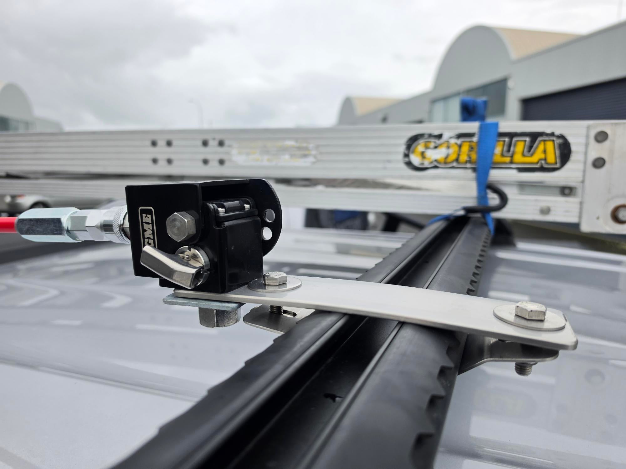Collection of Close-up of a black and silver roof rack mounting bracket attached to a vehicle roof rack in a gallery layout
