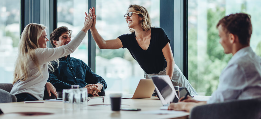 Collection of a team communicating around a table in a gallery layout
